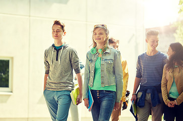 Image showing group of happy teenage students walking outdoors