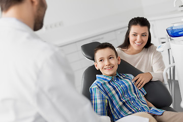 Image showing mother and son visiting dentist at dental clinic