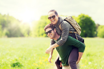 Image showing happy couple with backpacks having fun outdoors