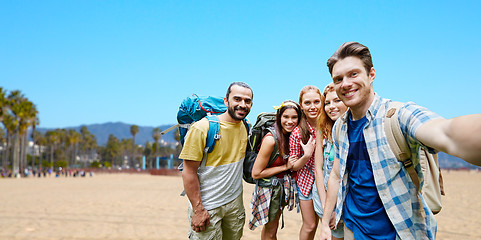 Image showing friends with backpacks taking selfie