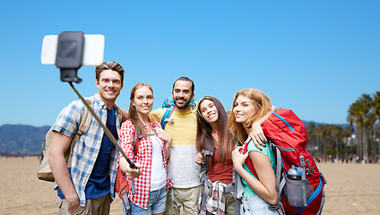 Image showing friends with backpacks taking selfie by smartphone