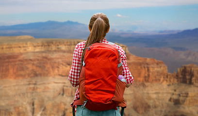 Image showing smiling woman with backpack over grand canyon