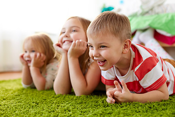 Image showing happy little kids lying on floor or carpet