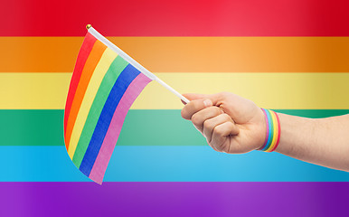 Image showing hand with gay pride rainbow flag and wristband