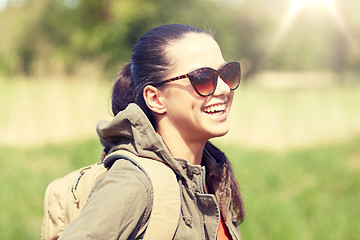 Image showing happy young woman with backpack hiking outdoors