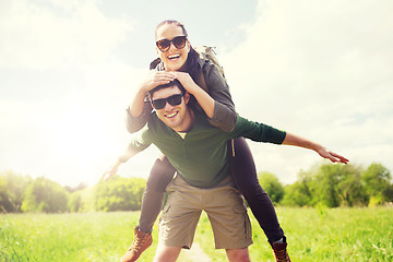 Image showing happy couple with backpacks having fun outdoors