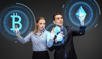 Image showing businesspeople with cryptocurrency holograms