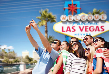 Image showing group of happy friends taking selfie by cell phone