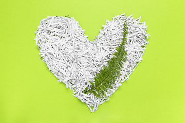 Image showing Heart made of shredded paper with a green leaf inside