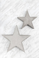 Image showing Two concrete stars on marble background