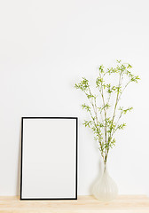 Image showing Picture frame and spring tree branches in a vase