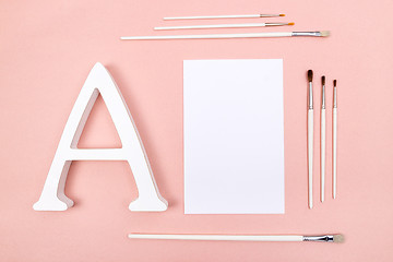 Image showing Blank paper, letter A and paintbrushes