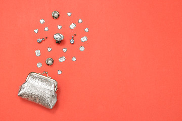 Image showing Silver purse, gems and jewelry on pink background