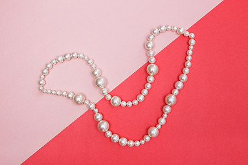 Image showing Shiny pearl necklace on pink background