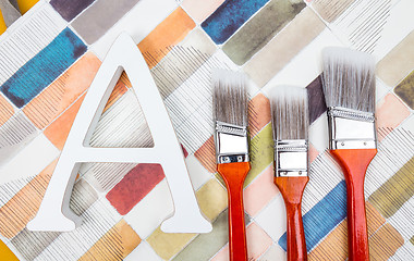 Image showing Paint brushes and letter A on watercolor background