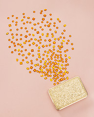 Image showing Gemstones spilling out of a golden purse