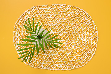 Image showing Palm leaves in a vase on a decorative yellow background