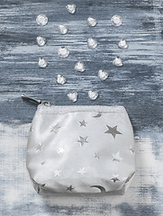 Image showing Silver purse and gemstones on gray artistic background