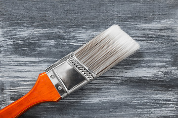 Image showing Red paintbrush on gray painted background