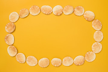 Image showing Frame made of mini pita bread on yellow background