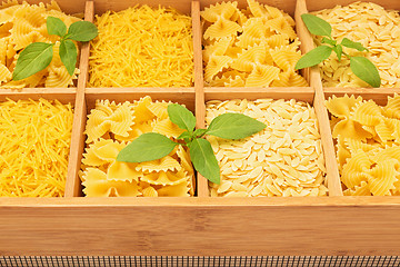 Image showing Wooden storage box with different types of pasta