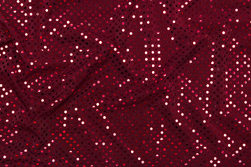 Image showing Dark red fabric with sparkling metallic dots design