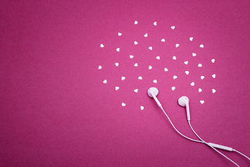 Image showing Earphones and hearts on vibrant purple background