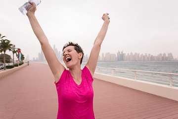 Image showing young woman celebrating a successful training run