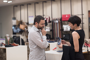 Image showing couple chooses shoes At Shoe Store