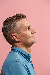 Image showing The happy businessman standing and smiling against pink background.