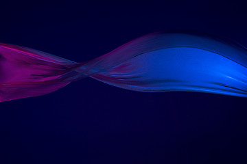 Image showing Smooth elegant transparent blue cloth separated on blue background.