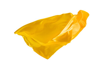 Image showing Smooth elegant transparent yellow cloth separated on white background.