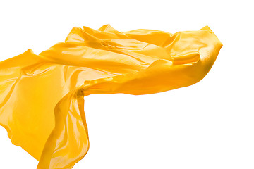 Image showing Smooth elegant transparent yellow cloth separated on white background.