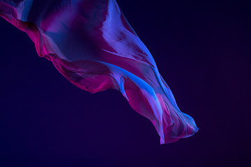 Image showing Smooth elegant transparent blue cloth separated on blue background.