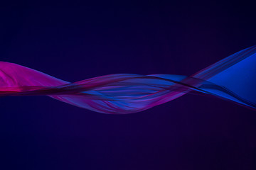 Image showing Smooth elegant transparent blue cloth separated on blue background.