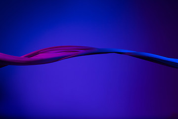 Image showing Smooth elegant transparent blue cloth separated on blue background.