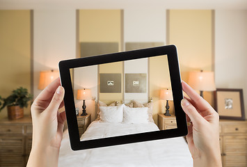 Image showing Female Hands Holding Computer Tablet In Room with Photo on Scree