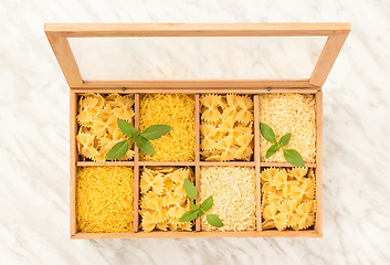 Image showing Wooden storage box with different types of pasta