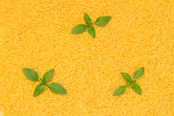 Image showing Noodles background decorated with basil leaves