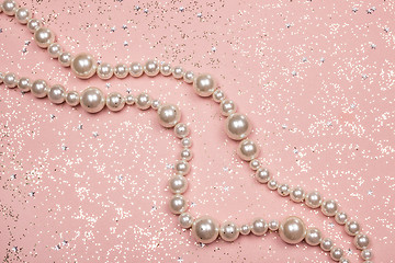 Image showing Pearl necklace on glitter pink background