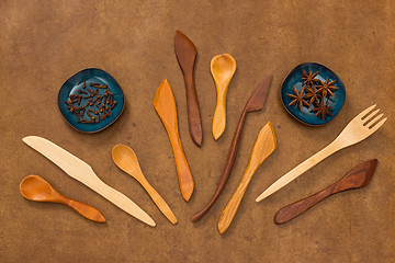 Image showing Handcrafted wooden utensils and spices on leather background