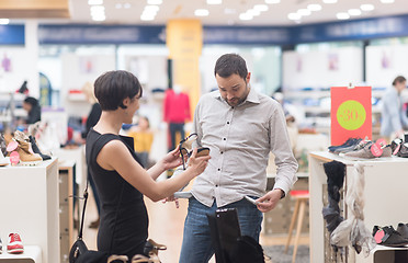 Image showing couple chooses shoes At Shoe Store