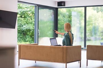 Image showing Young woman using laptop at home