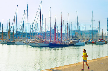 Image showing Woman running at marina. Barcelona