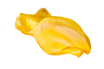 Image showing Smooth elegant transparent yellow cloth separated on white background.