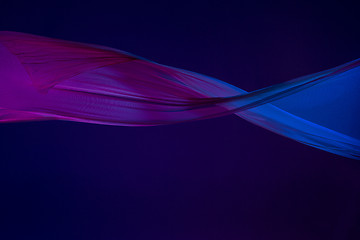 Image showing Smooth elegant transparent blue cloth separated on blue background.