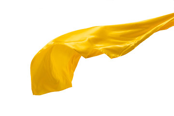 Image showing Smooth elegant transparent yellow cloth separated on white background.