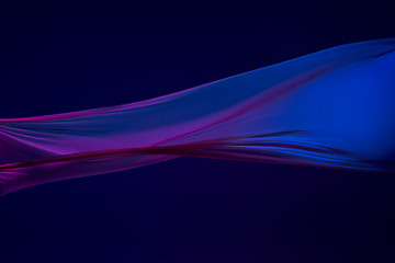 Image showing Smooth elegant transparent blue cloth separated on blue background.