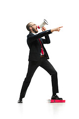 Image showing Side view of a man screaming on the megaphone over white background