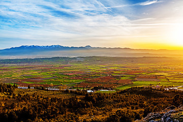 Image showing Beutiful sunset over colored agricultiral fields